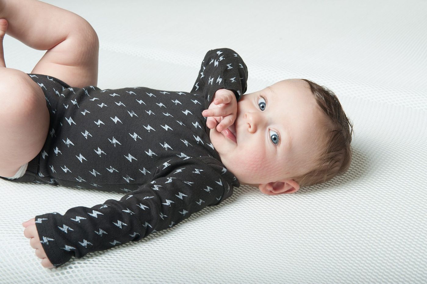 Baby on its back on the mattress