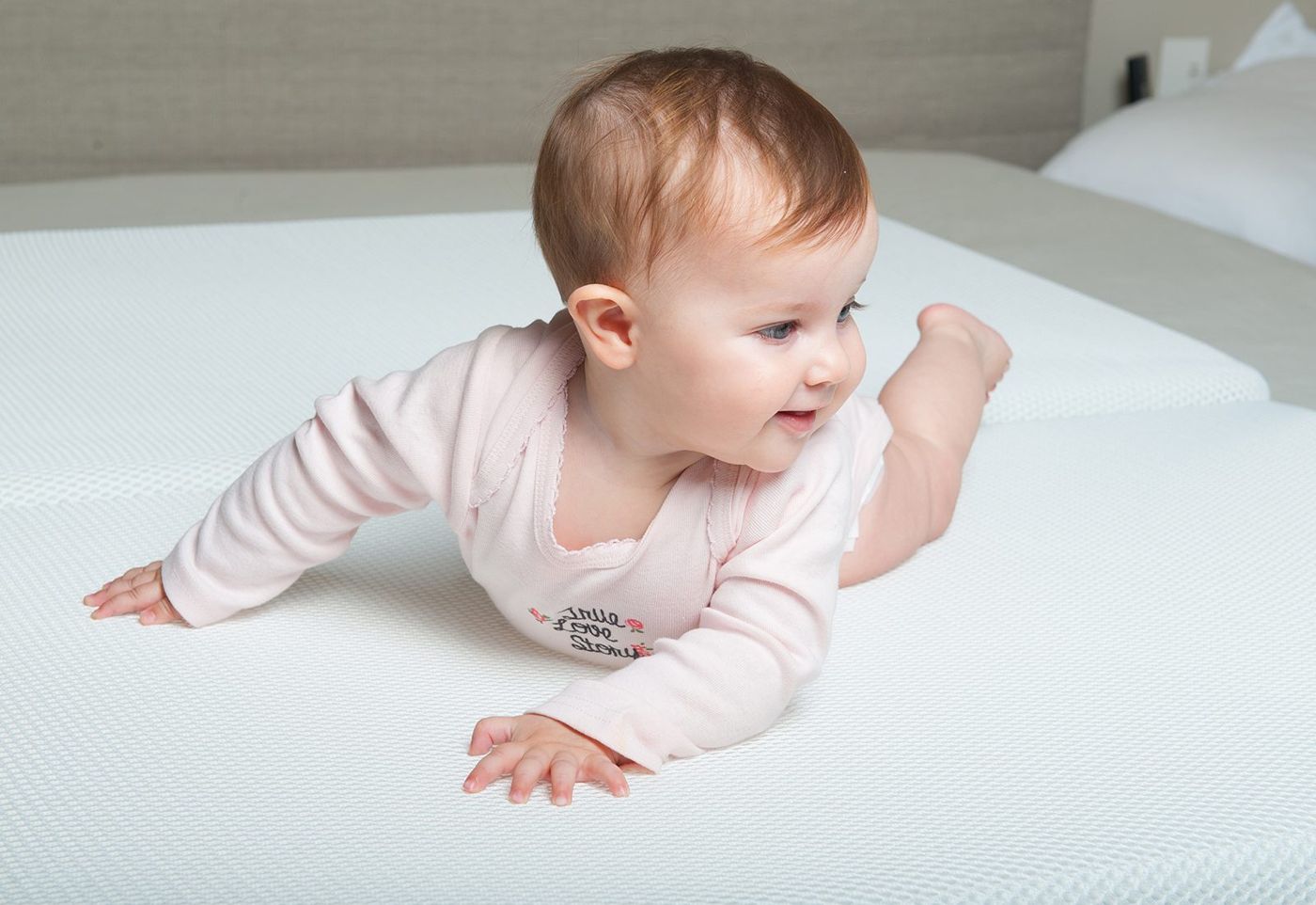 Baby on the white NUMU breathable mattress